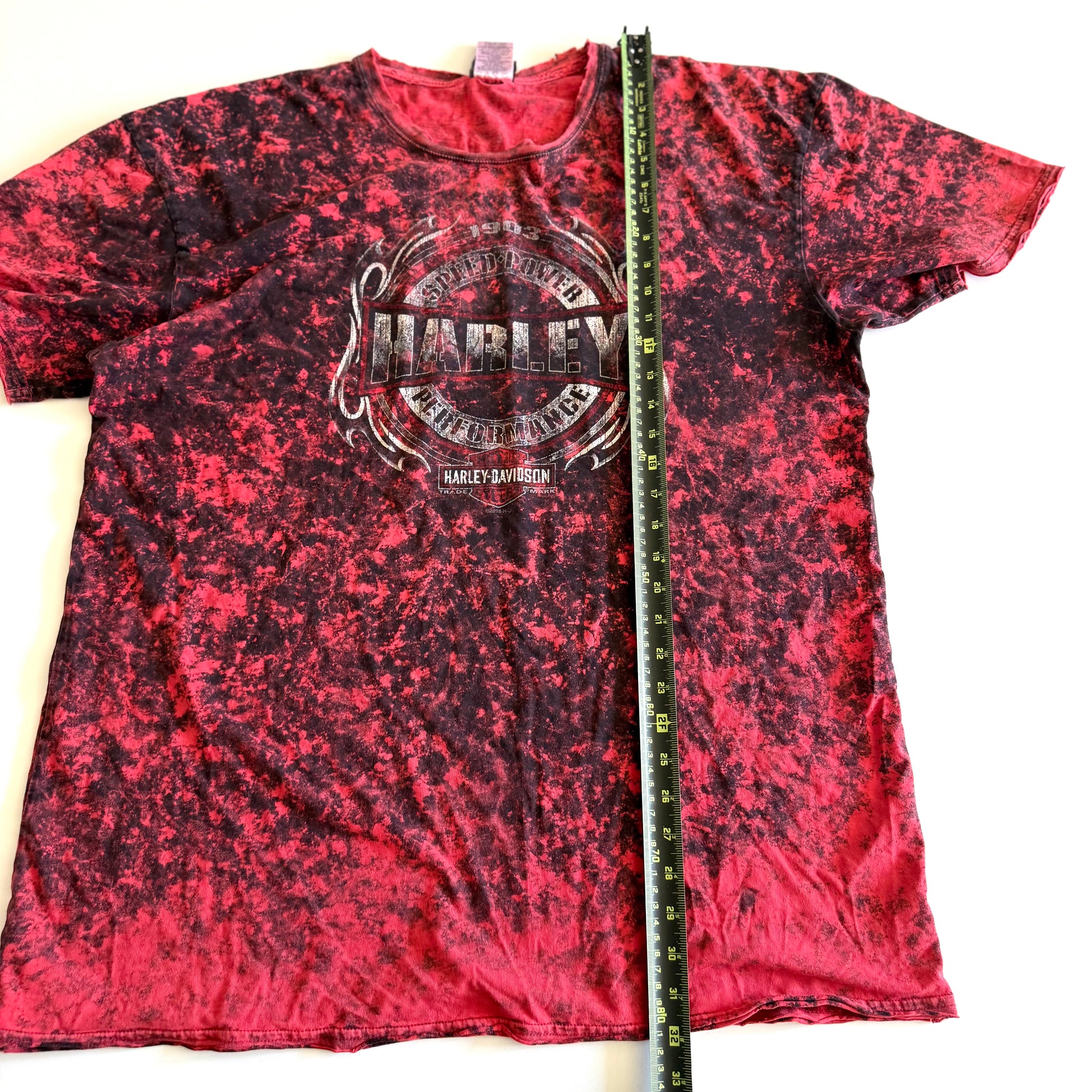 Pinky red t-shirt with black ie dye effect, and the harley davidson logo on the front - on a white background.  With a tape measure aid on it. 