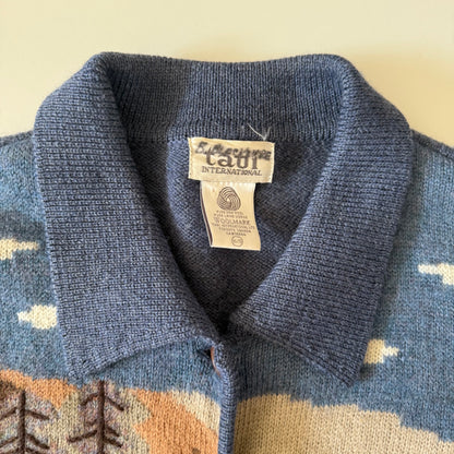 Close-up of a blue sweater collar with a label on a patterned background