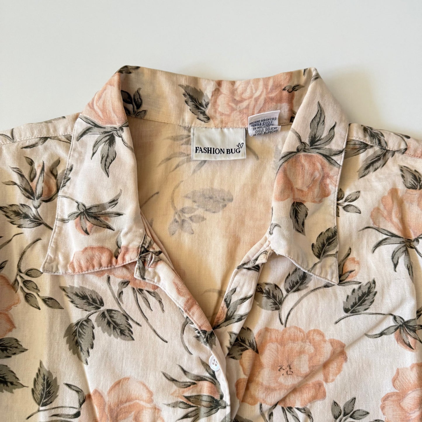 Floral patterned shirt with a visible brand label on a white background