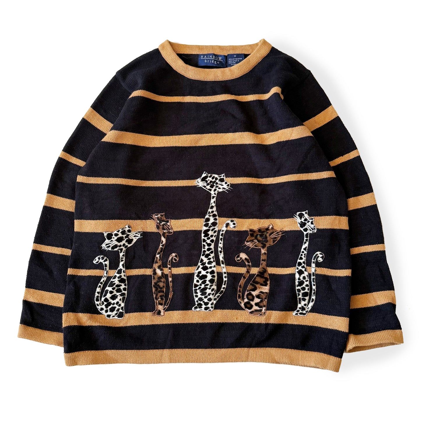 Black and gold striped sweater with embroidered leopards on a white background