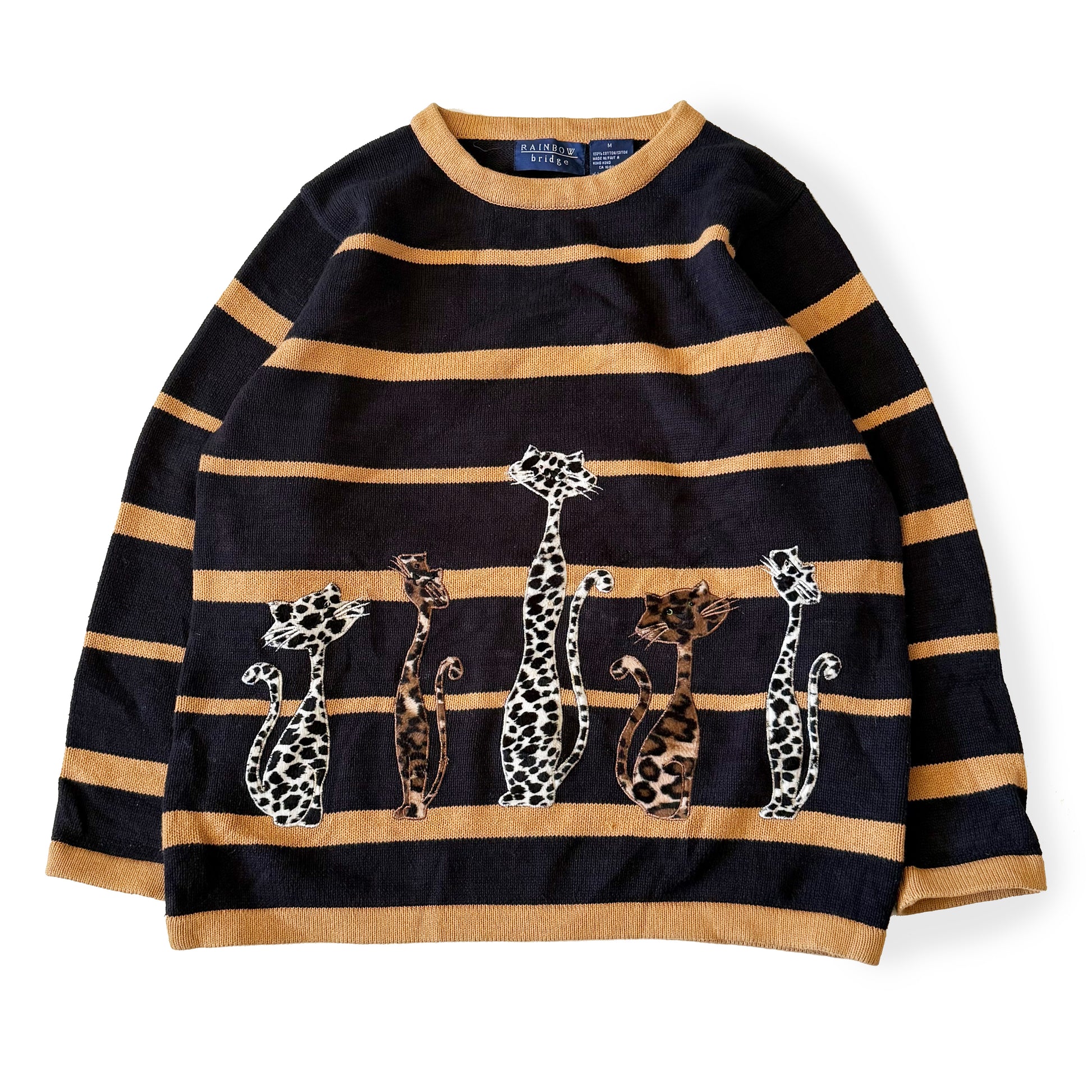 Black and gold striped sweater with embroidered leopards on a white background