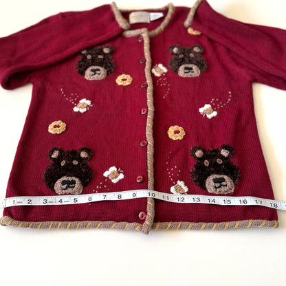 Bear cardigan with measuring tape on it. 