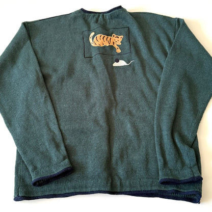 Green sweater with a pocket featuring a tiger and whale design on a white background