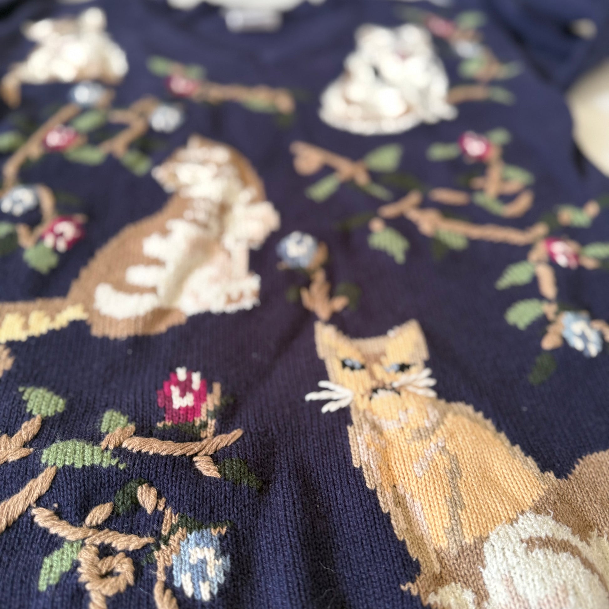 Embroidered fabric with fox and floral patterns on a dark background