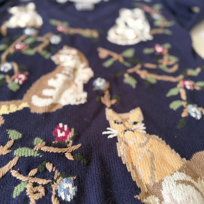 Embroidered fabric with fox and floral patterns on a dark background