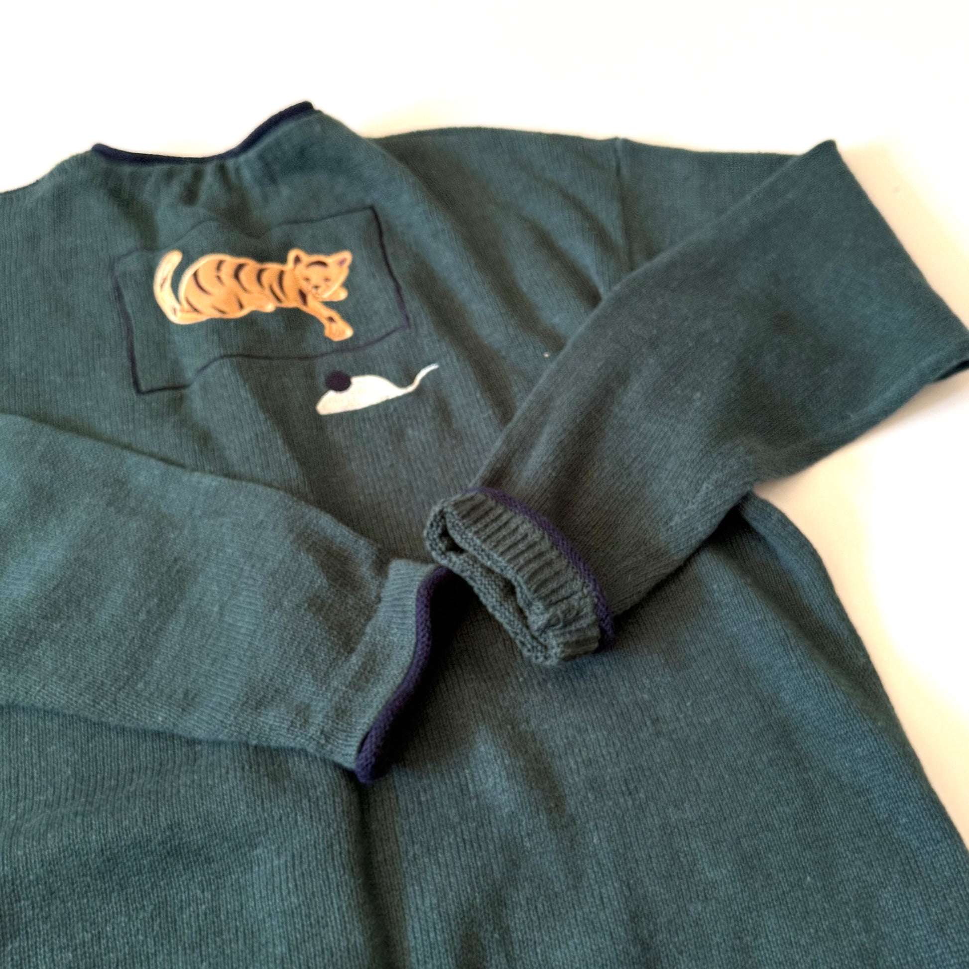 Dark gray sweater with a tiger patch on a white background