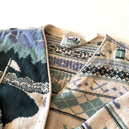 Tag of the cardigan with white backdrop at top.