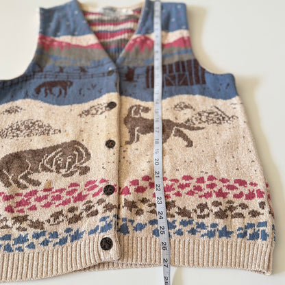 Knitted vest with animal pattern and measuring tape on a white background