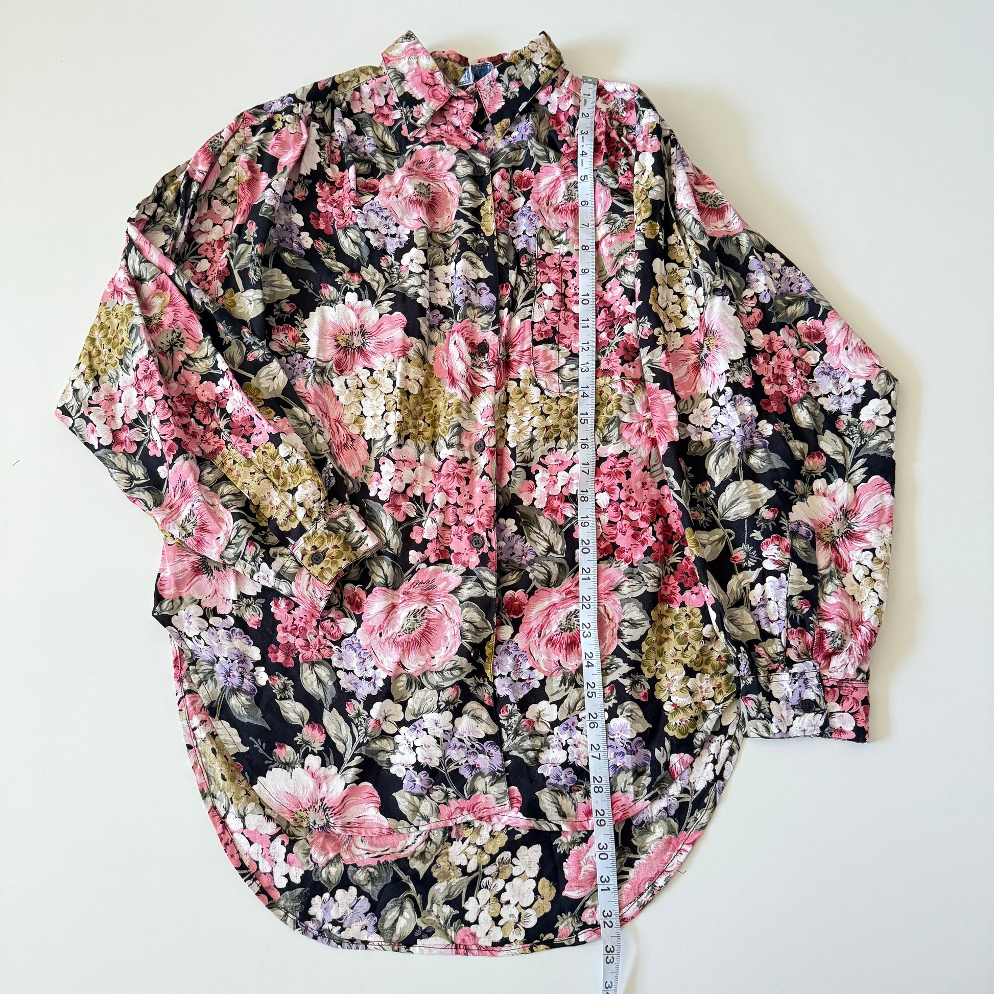 Floral patterned shirt with a measuring tape on a white background