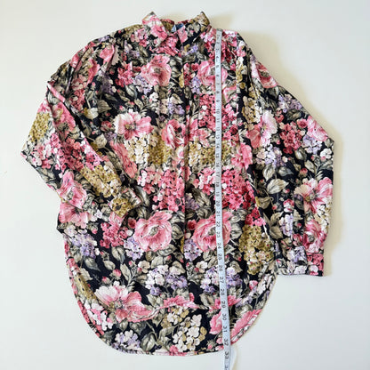 Floral patterned shirt with a measuring tape on a white background