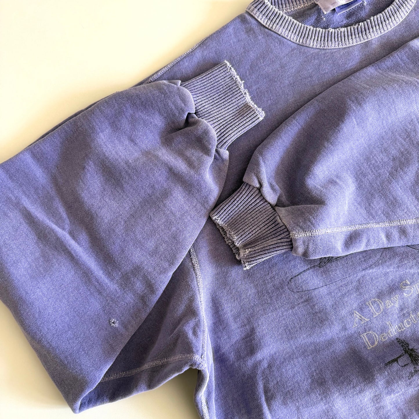 Close up of distressed sleeve cuffs. 