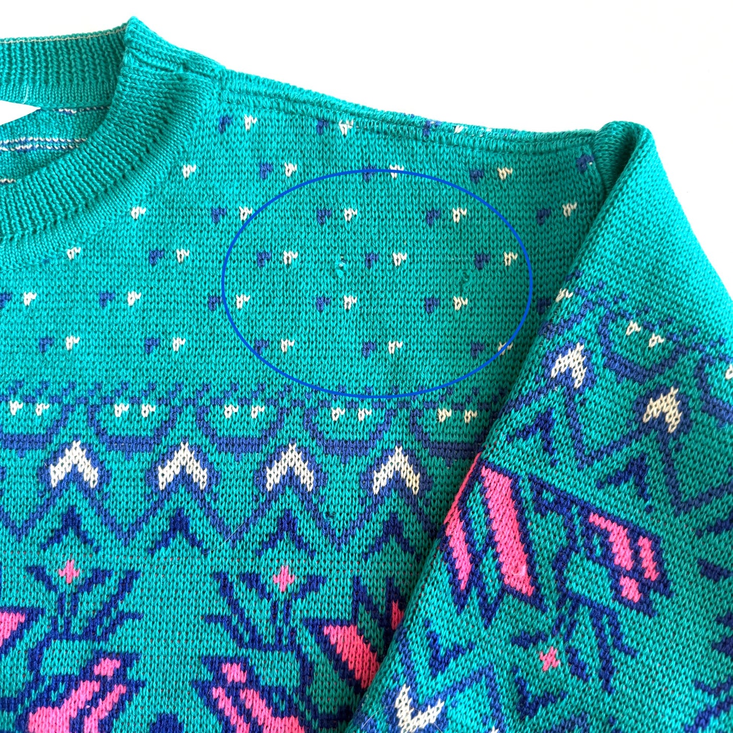 Circled image of a few snags in the sweater.