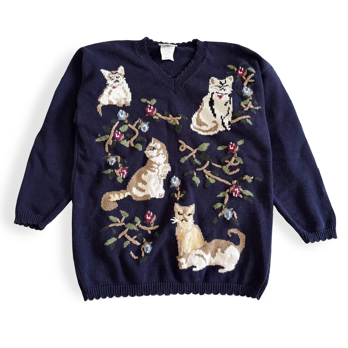 Navy blue sweater with cat illustrations on a white background