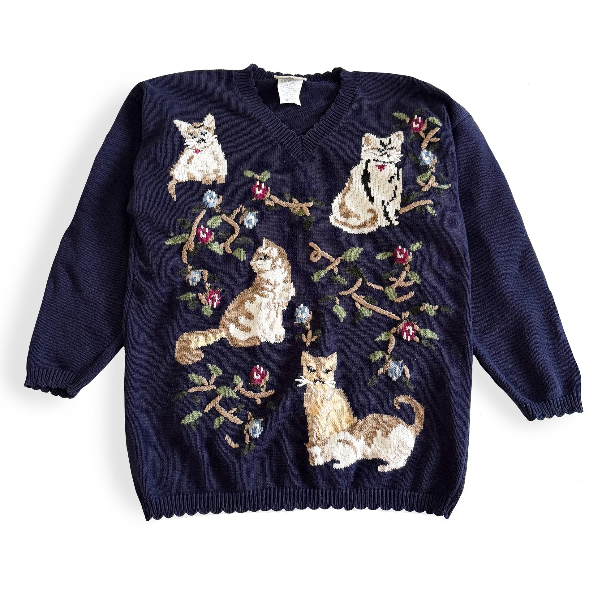 Navy blue sweater with cat illustrations on a white background