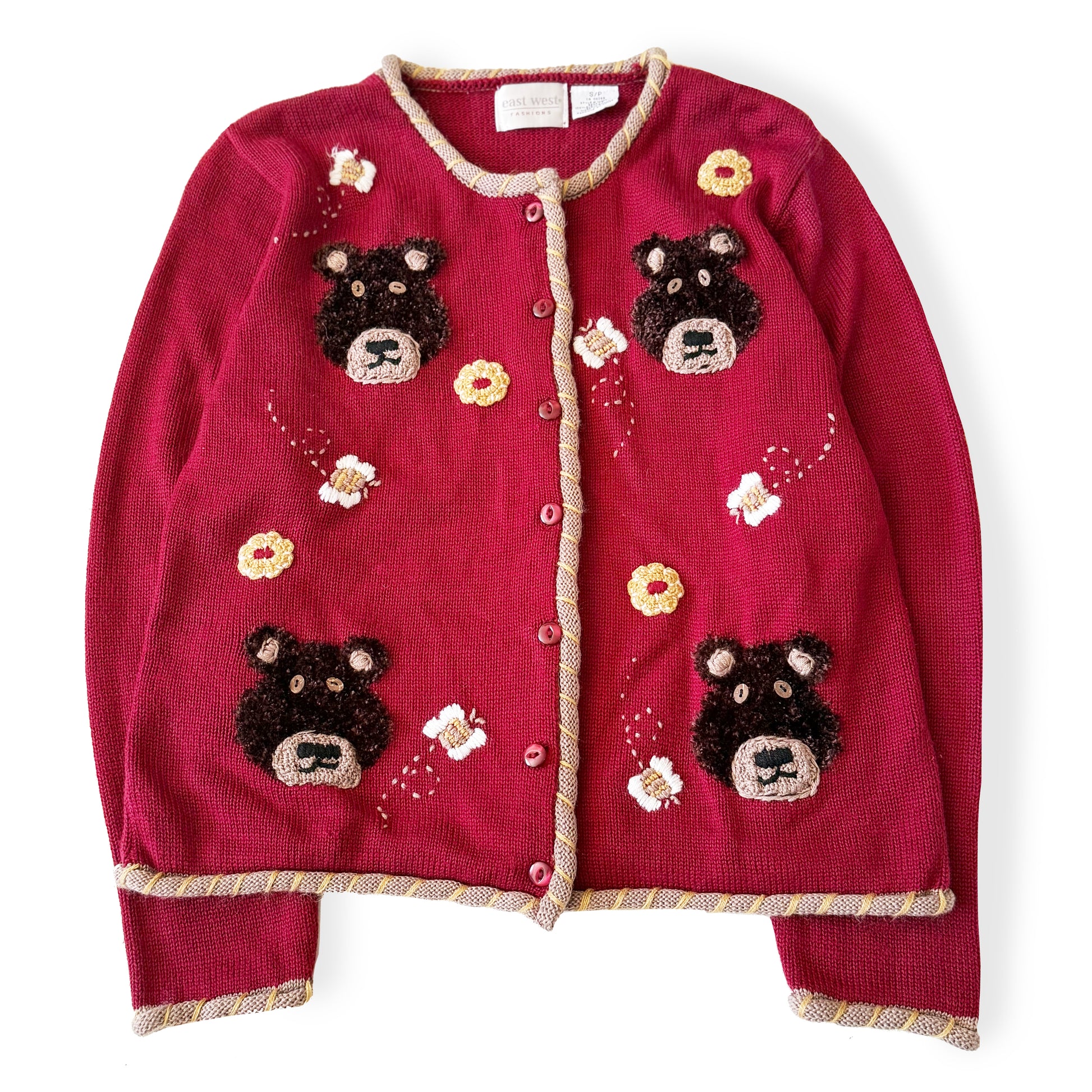 Red cardigan with bear appliqués on a white background