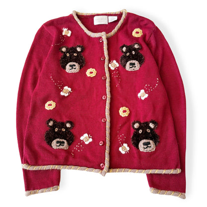 Red cardigan with bear appliqués on a white background