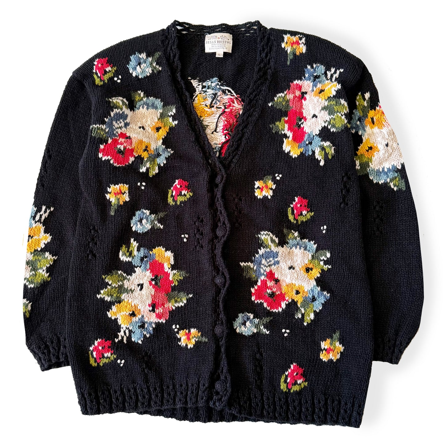 Black cardigan with colorful floral patterns on a white background