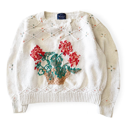Knitted sweater with floral design on a white background