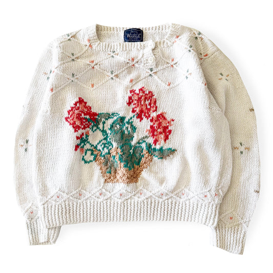 Knitted sweater with floral design on a white background
