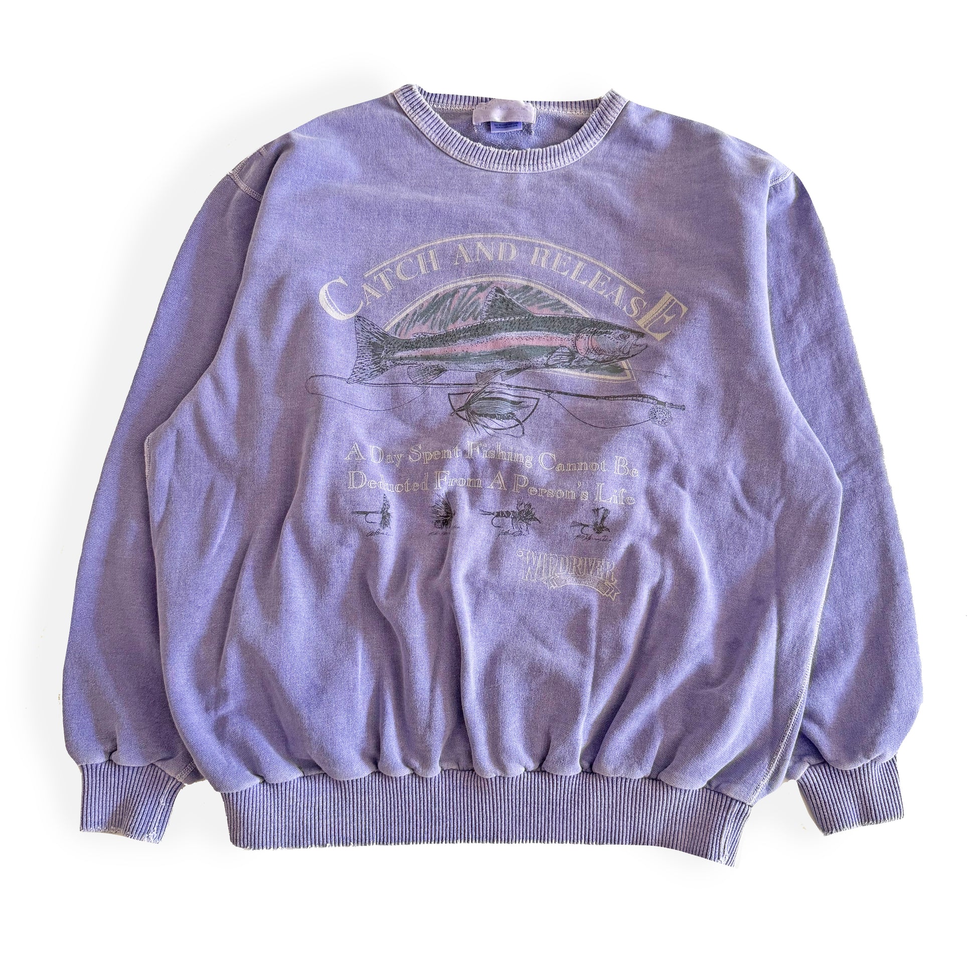 Light purple sweatshirt with fishing theme images and words on the front, on a white backdrop. 