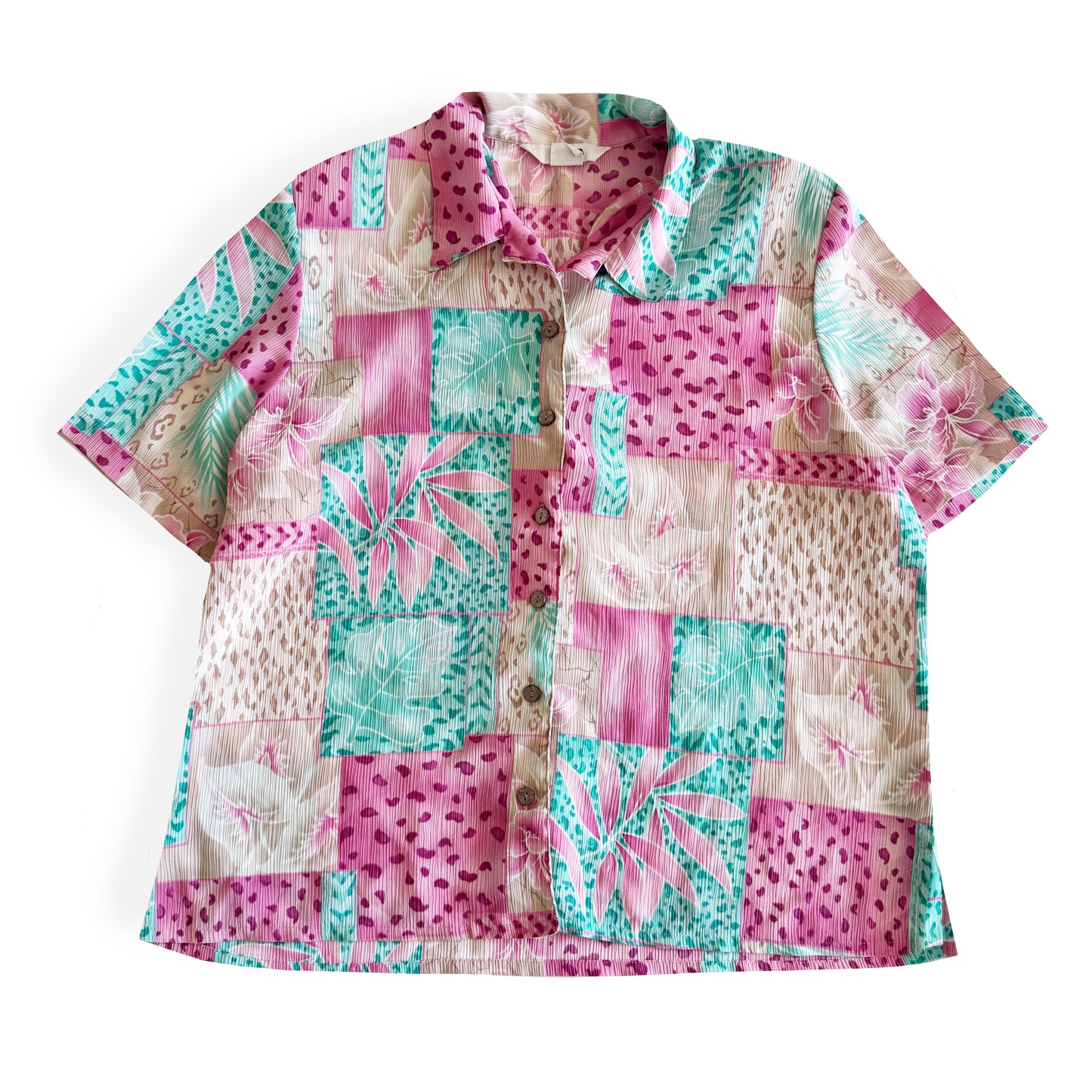 Button down bright coloured (tan, pink, teal) shirt with tropical and animal print patterns on it - placed on a white background. 