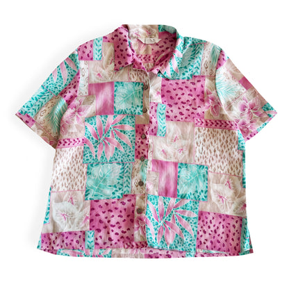 Button down bright coloured (tan, pink, teal) shirt with tropical and animal print patterns on it - placed on a white background. 