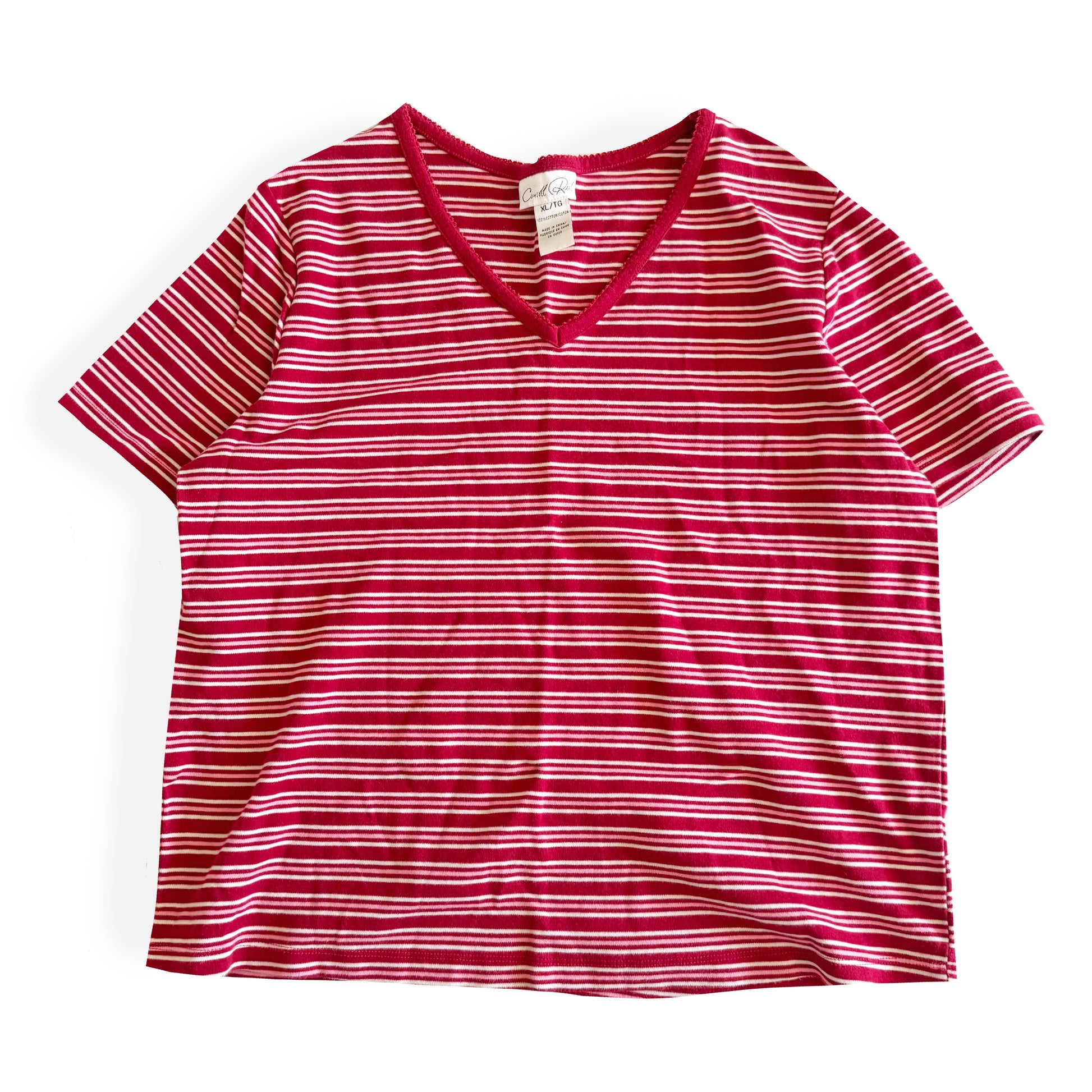 White, pink, and red striped t-shirt with a v-neck collar on a white backdrop. 