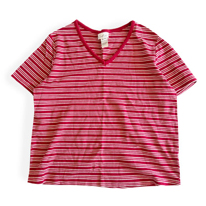 White, pink, and red striped t-shirt with a v-neck collar on a white backdrop. 