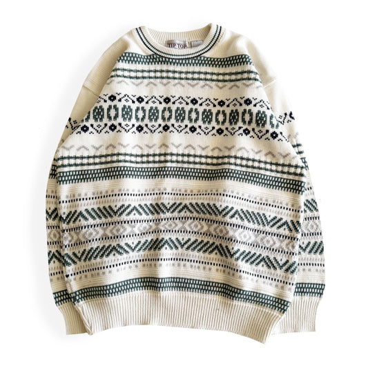 White knitwear sweater with a geometric patterns on it - on a white background. 