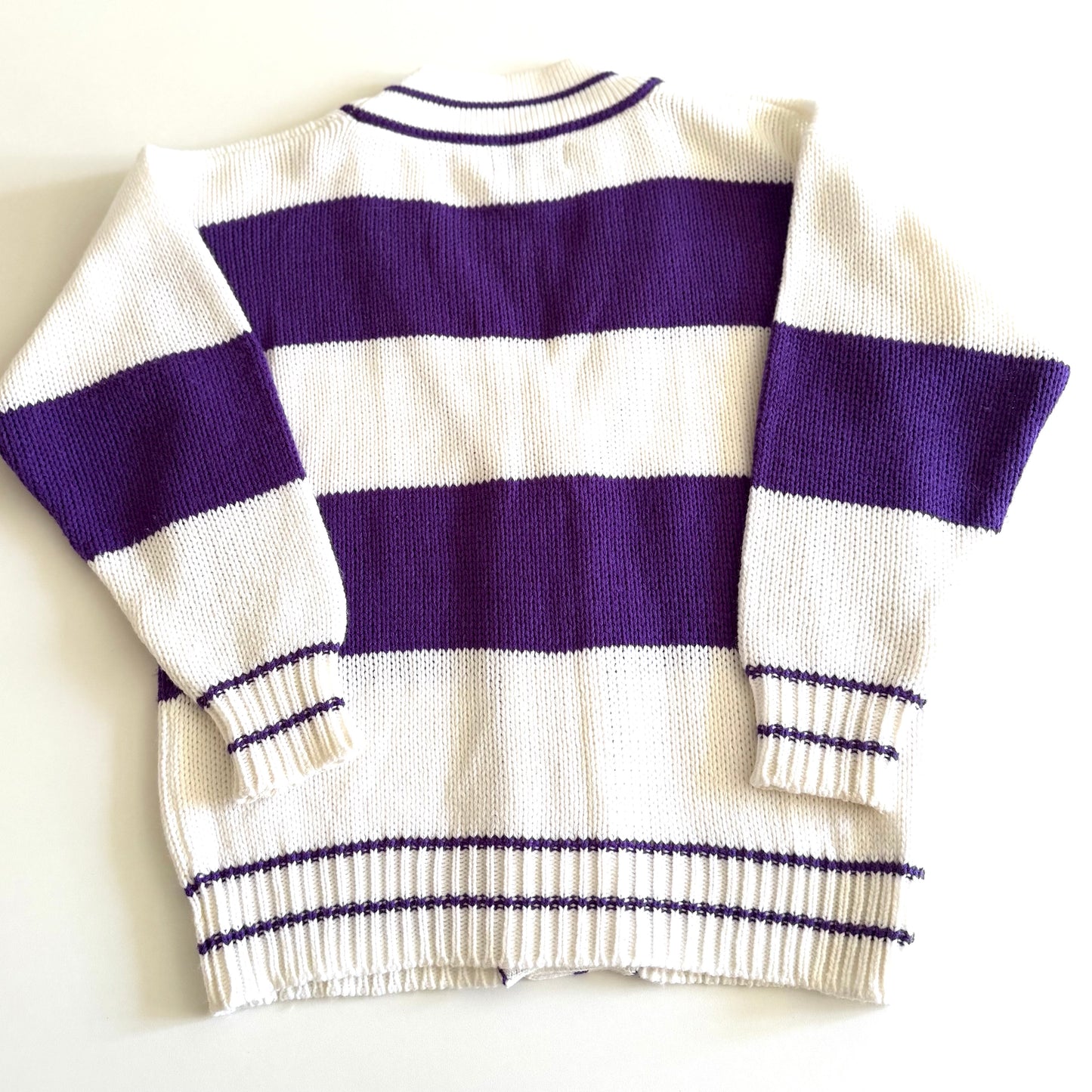 Back side of... 1990's preppy style - purple and white striped cardigan on a white backdrop. 