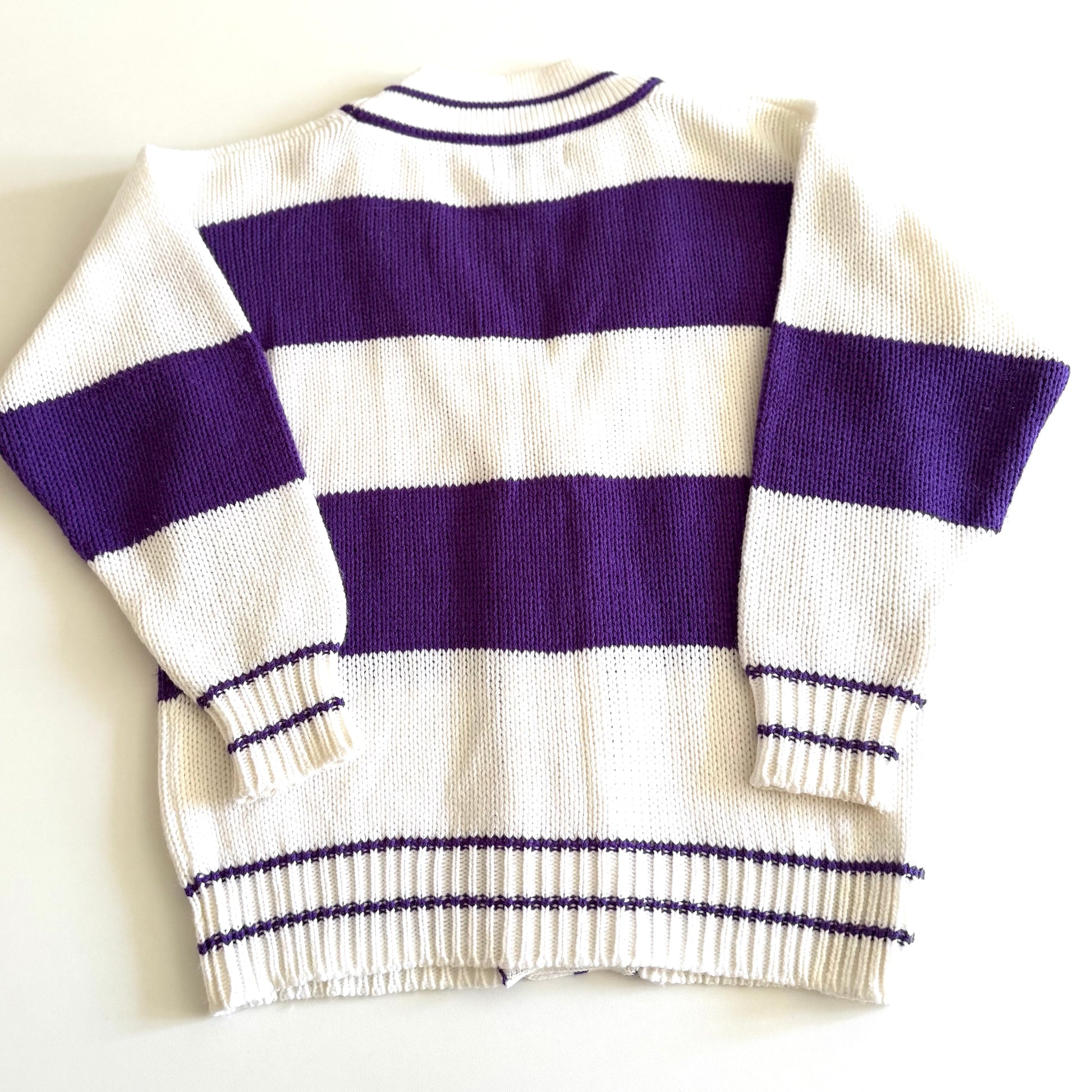 Back side of... 1990's preppy style - purple and white striped cardigan on a white backdrop. 