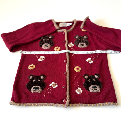 Bear cardigan with meausring tape on it. 