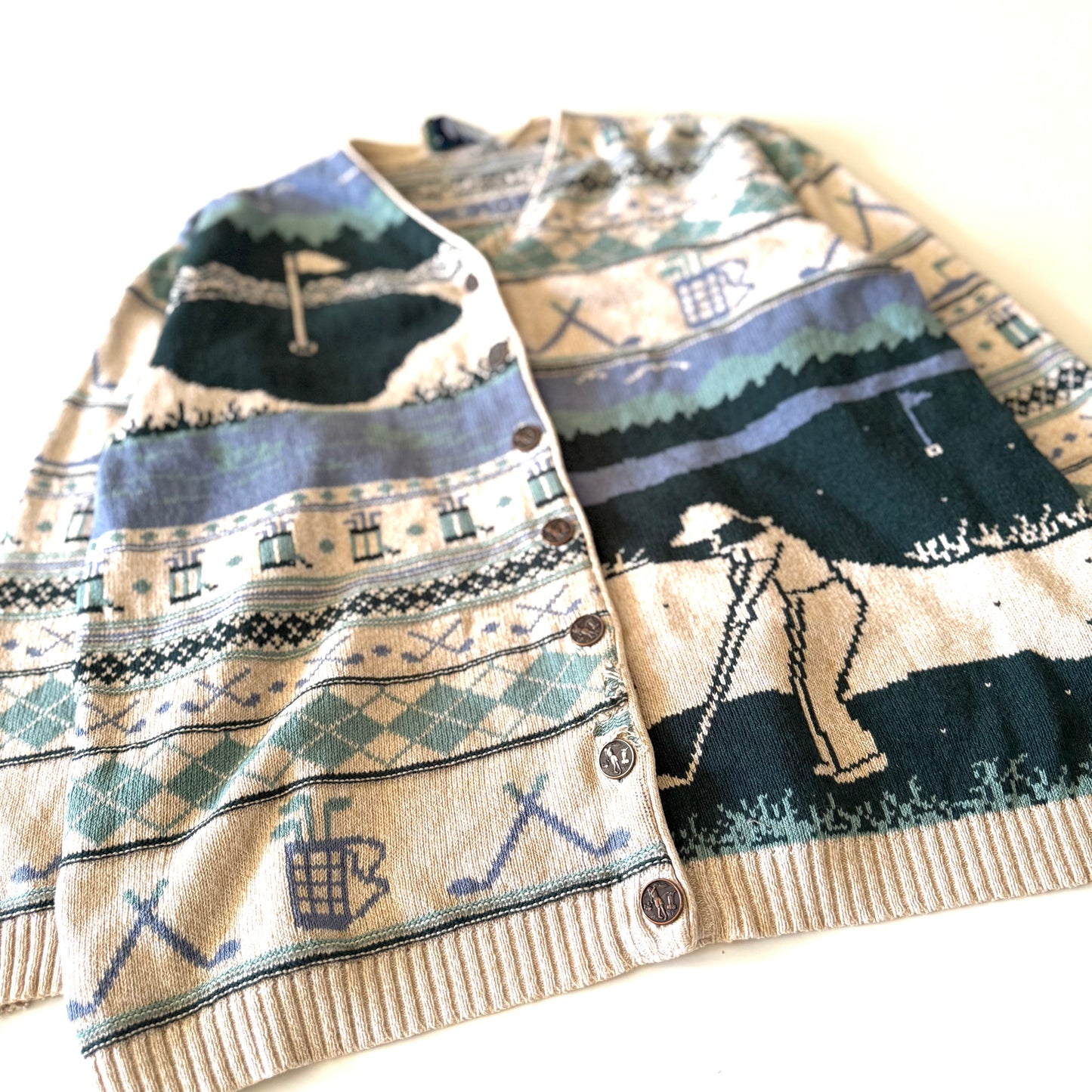 Golf themed cardigan with a white backdrop. 