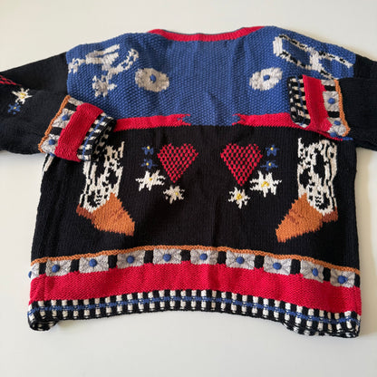 Colorful knitted sweater with patterned design on a white background