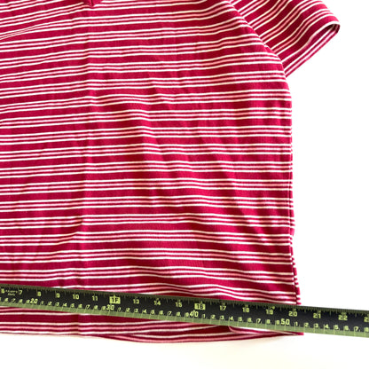 White, pink, and red striped t-shirt with a v-neck collar on a white backdrop - plus a measuring tape laid out on it. 