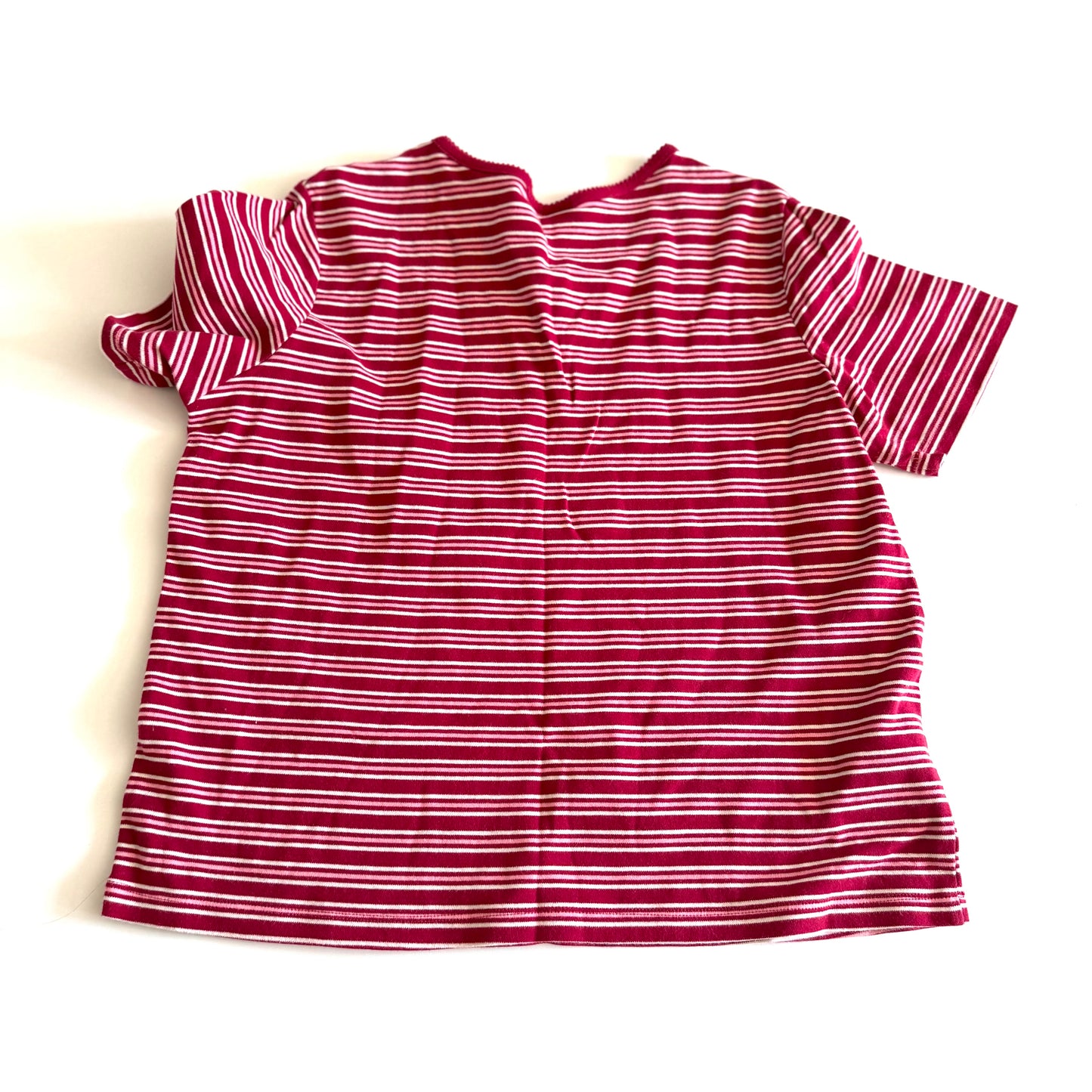The backside of a white, pink, and red striped t-shirt with a v-neck collar on a white backdrop. 