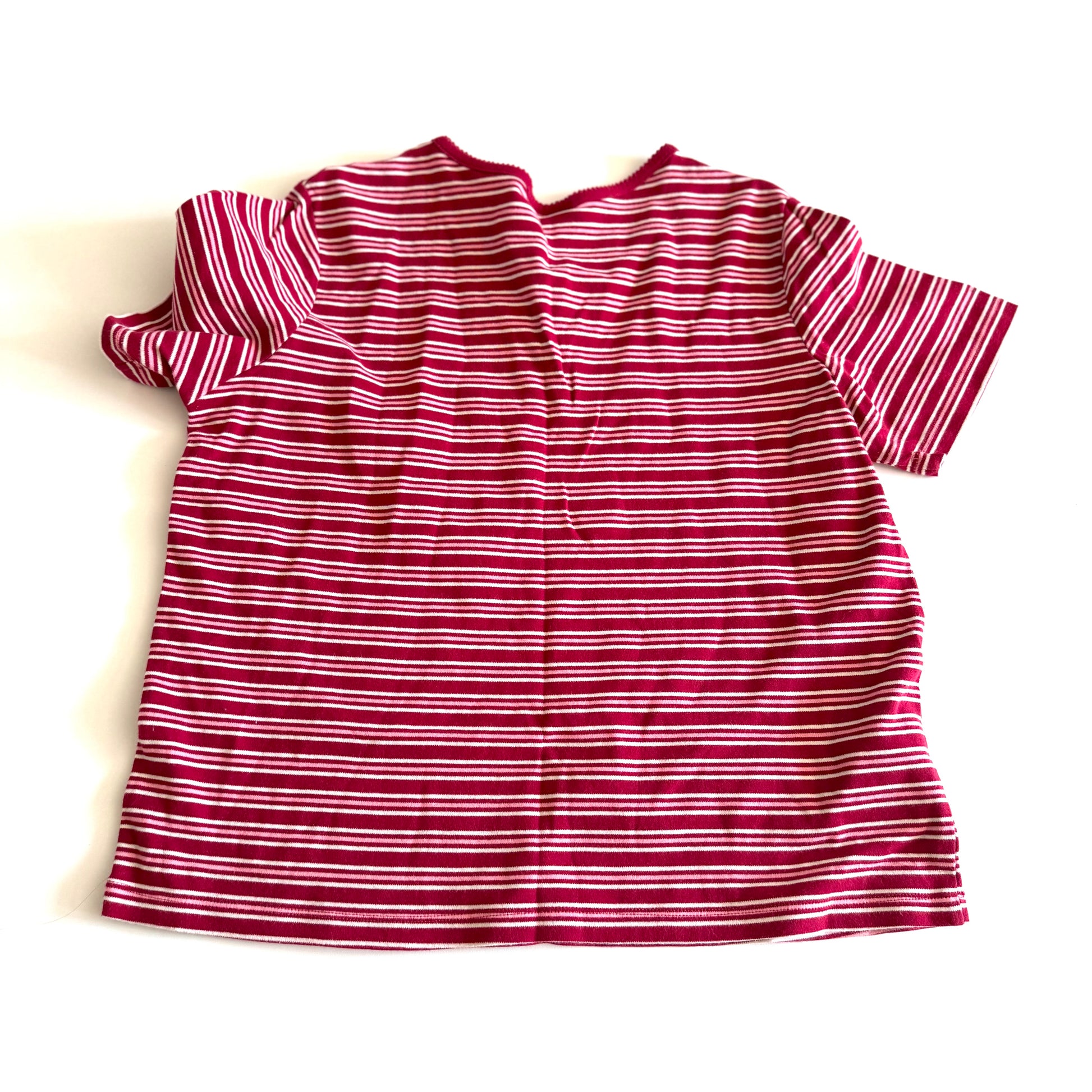 The backside of a white, pink, and red striped t-shirt with a v-neck collar on a white backdrop. 