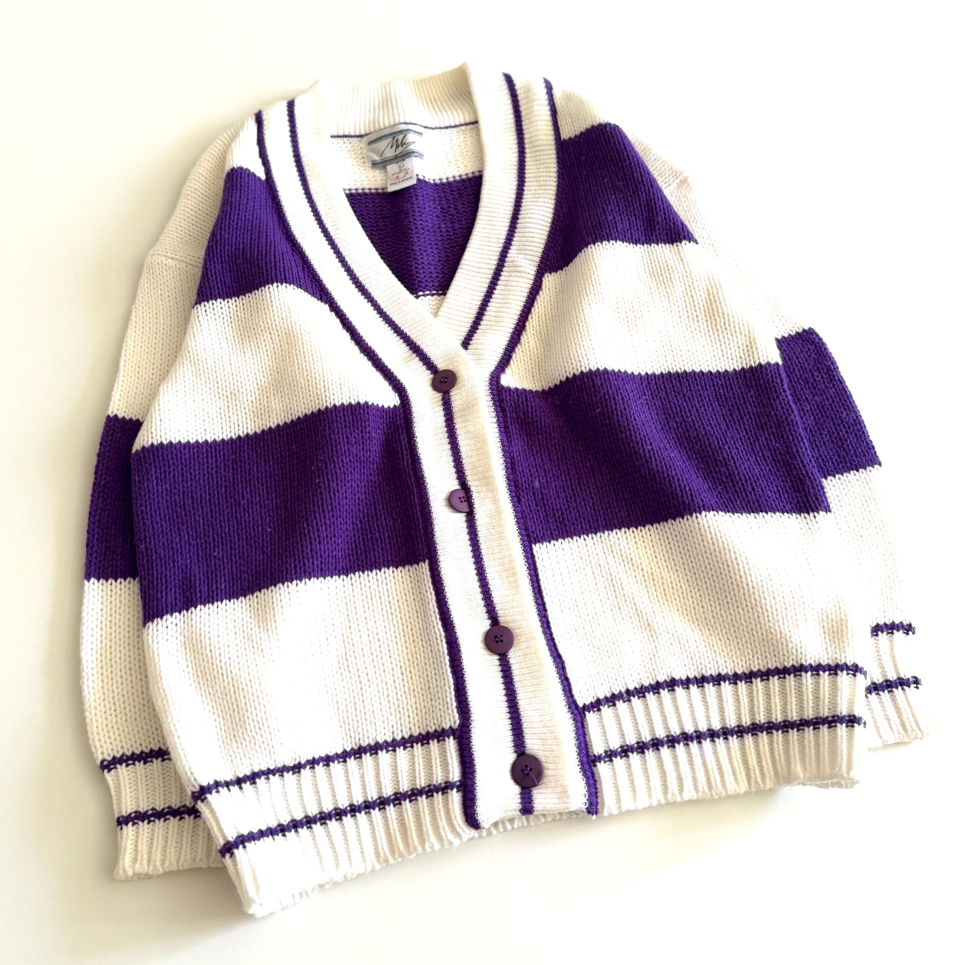 1990's preppy style - purple and white striped cardigan on a white backdrop. 