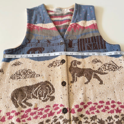 Patterned sweater vest with animals and nature design, partially shown with a measuring tape.