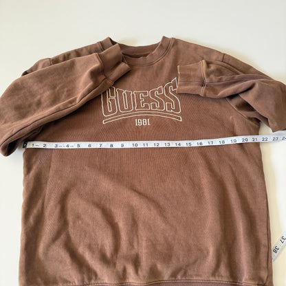 Brown Guess sweatshirt with a measuring tape on a white background