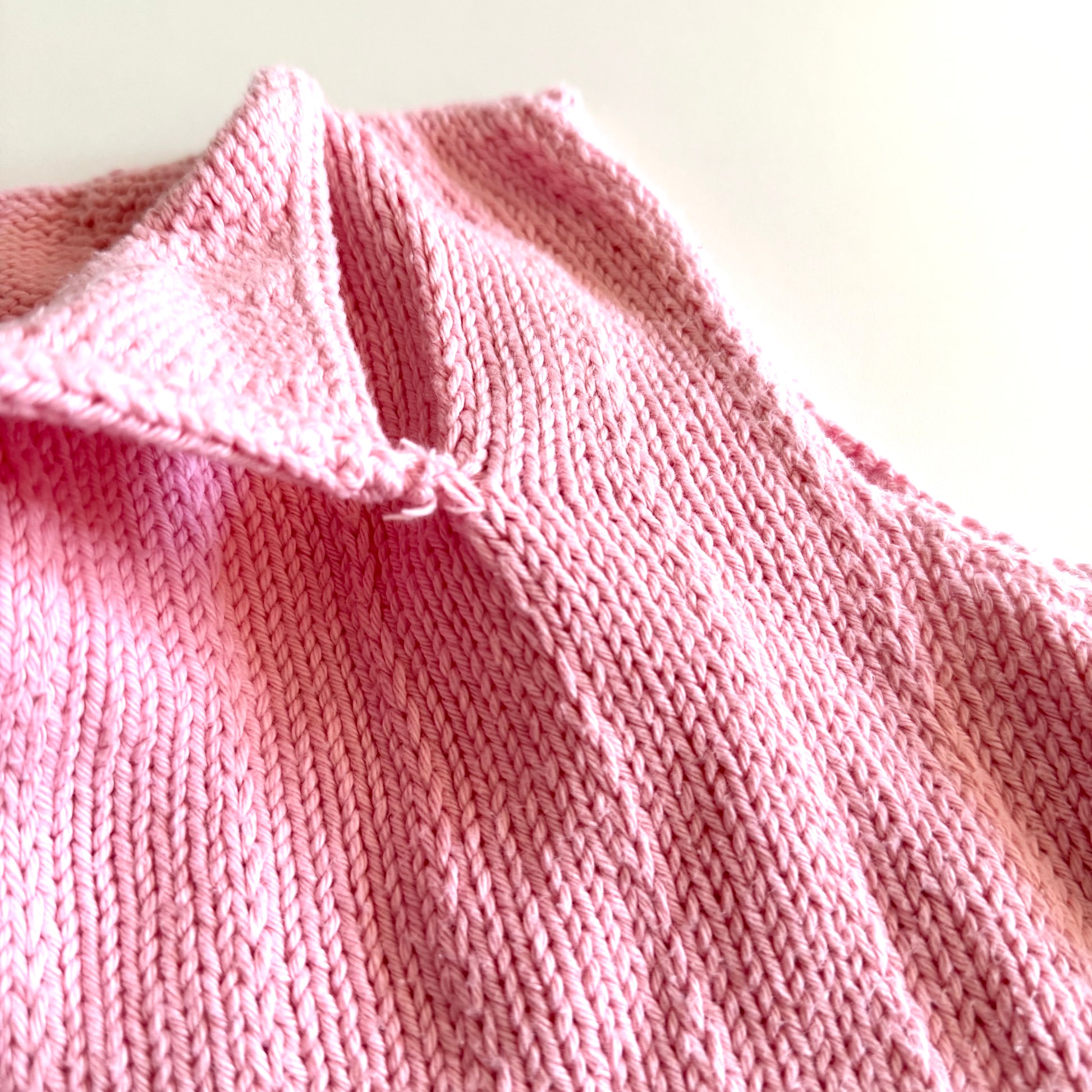 Showing that the opening collar detail is sewn into the shirt to stay open. 