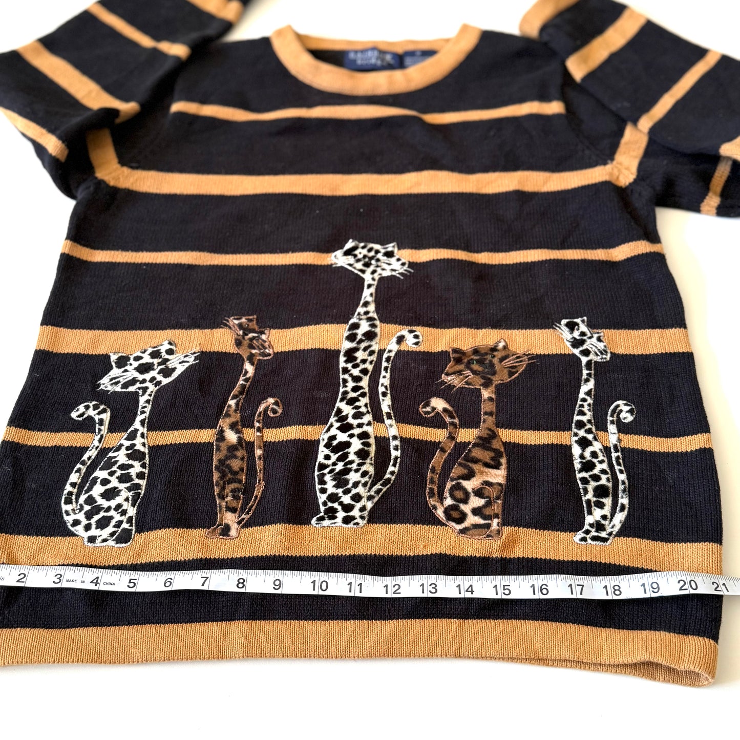 Striped sweater with animal designs on a white background