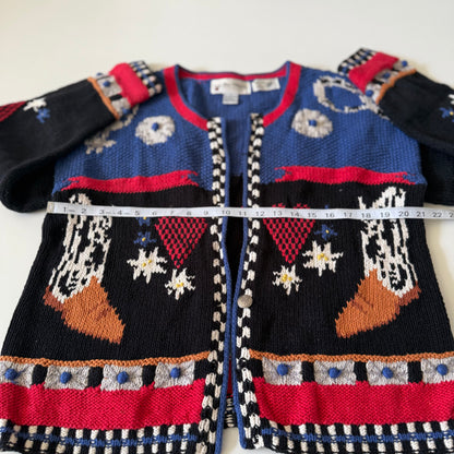 Knitted sweater with colorful patterns and a measuring tape on a white background
