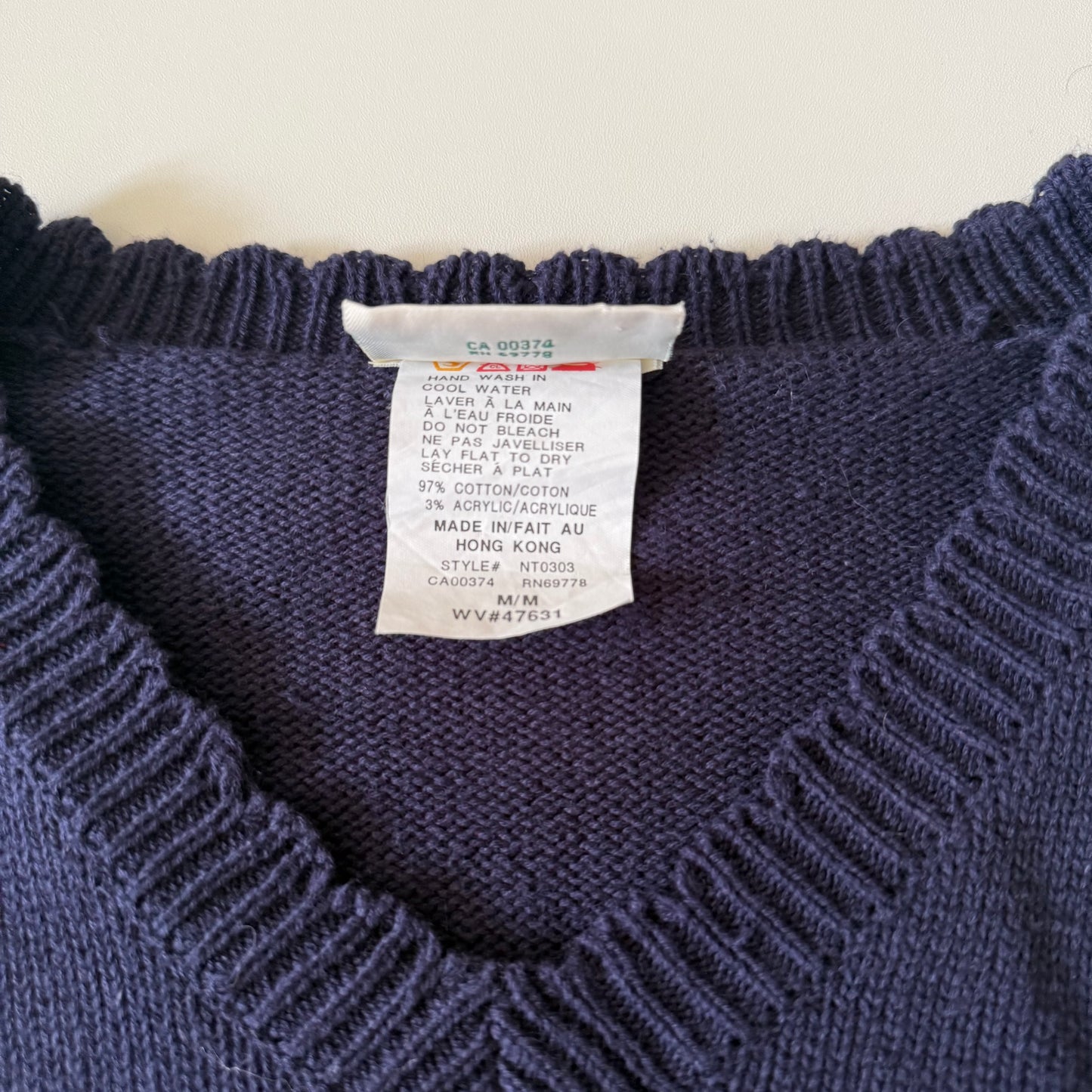 Navy sweater with a label on a light background