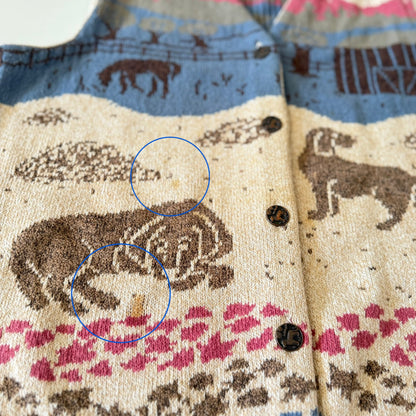 Close-up of a fabric with animal patterns and buttons, featuring two blue circles highlighting specific areas.