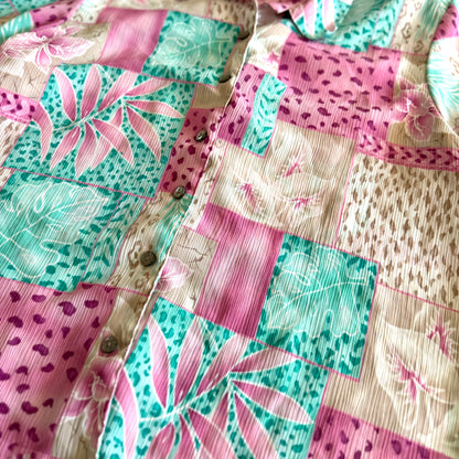Button down bright coloured (tan, pink, teal) shirt with tropical and animal print patterns on it .