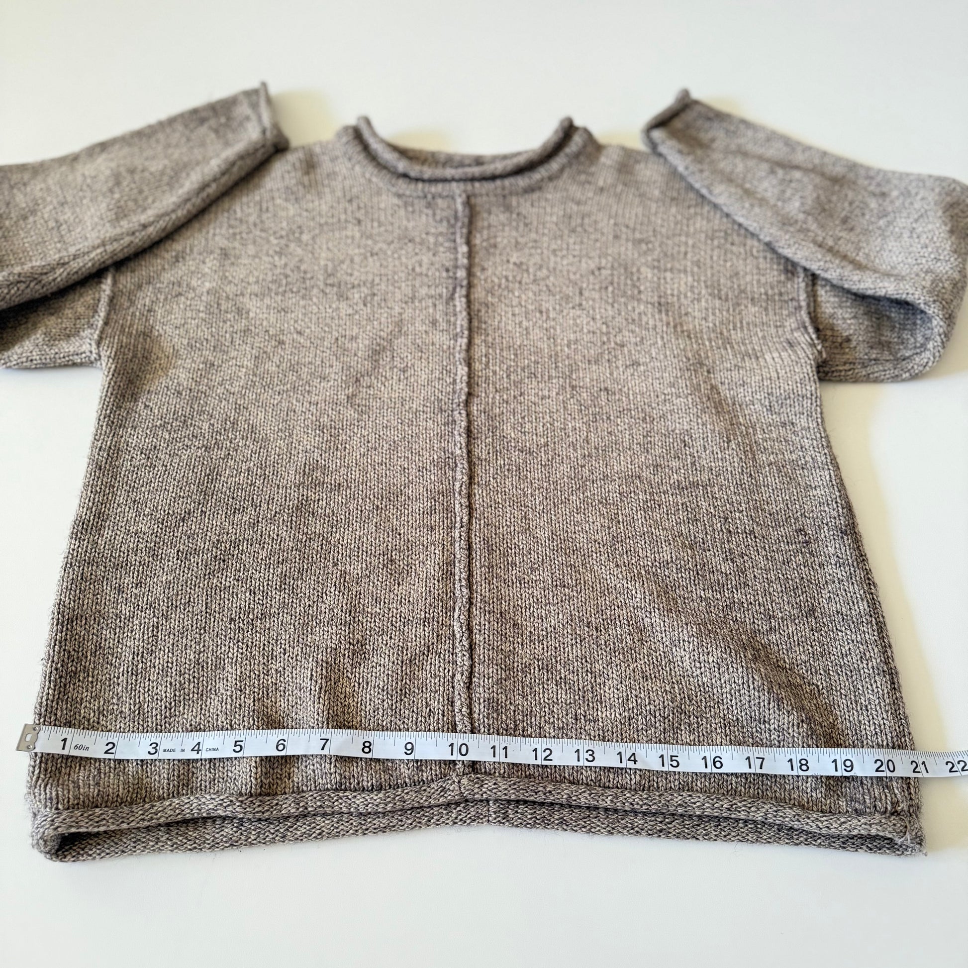 sweater with measuring tape on it