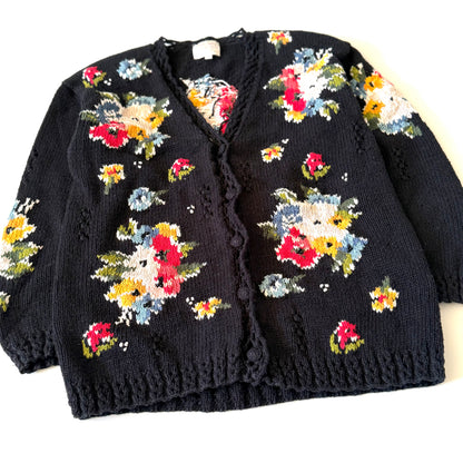 Black cardigan with colorful floral patterns on a white background