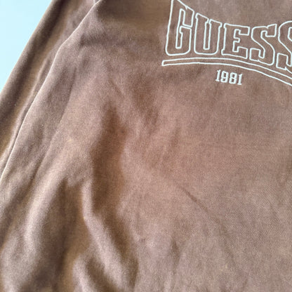 Brown fabric with Guess logo and '1981' text on a light blue background