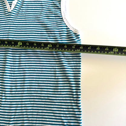 White and turquoise striped tank top with polo neckline, on a white backdrop and a measuring tape laid on top of it. 